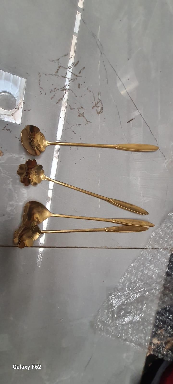 Golden floral spoon set of 4 featuring sunflower, rose, lily, and daisy designs by 1h8x0d-zb on a neutral background.