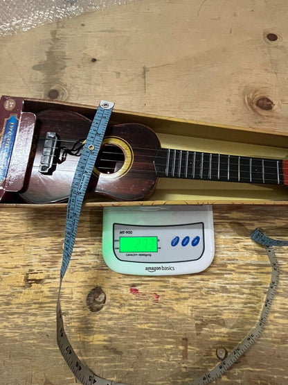Mini wooden finish plastic guitar by 1h8x0d-zb with 4 strings, showcasing its compact design and vibrant sound.