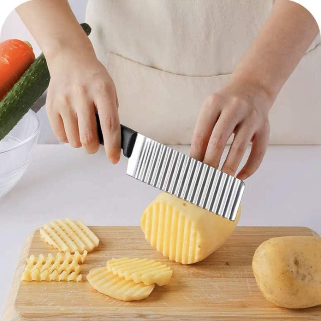 French stainless steel potato wave ripple knife with a textured blade and ergonomic handle on a wooden cutting board.