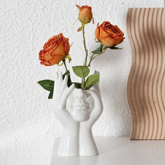 Aesthetic face vase by 1h8x0d-zb featuring a unique facial design and smooth ceramic finish.