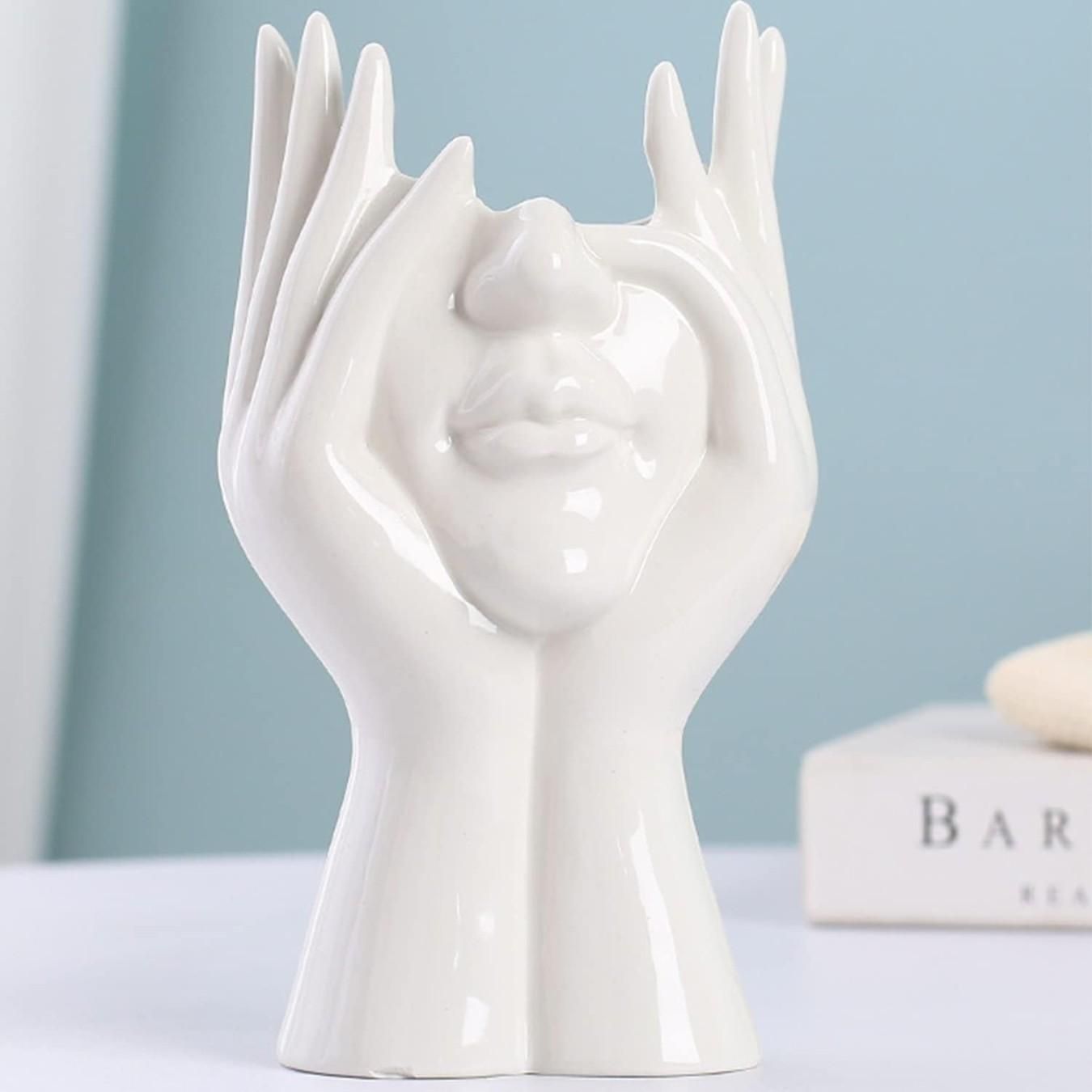 Aesthetic Face Vase by 1h8x0d-zb featuring a unique face design and smooth ceramic finish in neutral tones.