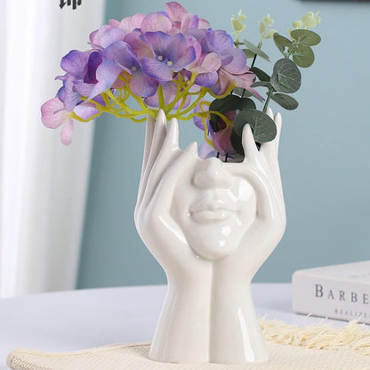 Aesthetic face vase by 1h8x0d-zb featuring a unique design and smooth ceramic finish, perfect for floral arrangements.