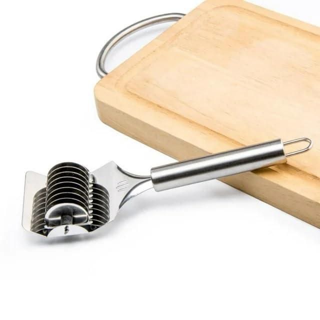 Stainless steel handheld dough and manual noodle pasta cutter tool by 1h8x0d-zb on a wooden surface.
