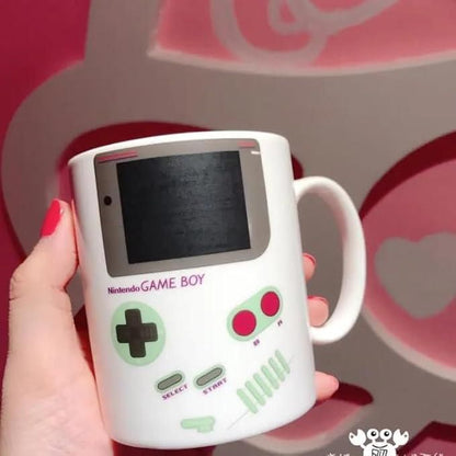 Gameboy heat changing coffee mug by 1h8x0d-zb displaying a nostalgic gaming design that transforms with hot liquid.